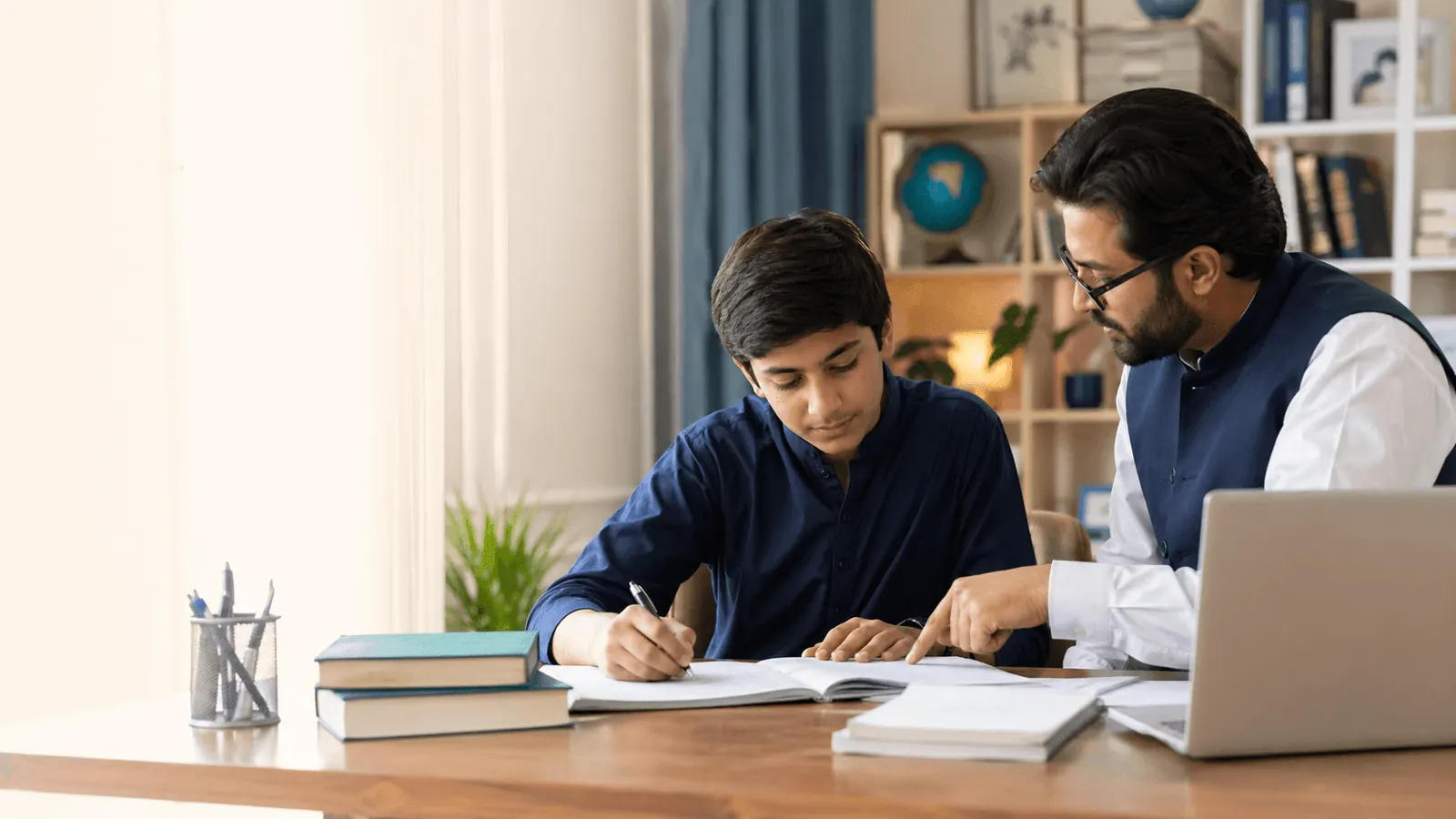 A tutor helping a student study at home